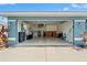 Spacious two-car garage offering ample storage space with a utility sink and lots of tools and equipment at 6324 35Th Avenue E Cir, Palmetto, FL 34221