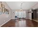 Open living room with hardwood floors, a rowing machine, and natural light from the window at 6324 35Th Avenue E Cir, Palmetto, FL 34221