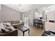 Bright living room features a comfortable sofa, tile floors, and sliding door access to the outdoor space at 6324 35Th Avenue E Cir, Palmetto, FL 34221