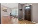 Living room with hardwood floors, a rowing machine, and a view of the front door at 6324 35Th Avenue E Cir, Palmetto, FL 34221
