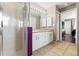 Spacious main bathroom with dual sinks, tile floors, a glass shower, and access to the main bedroom at 6324 35Th Avenue E Cir, Palmetto, FL 34221