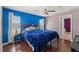 Charming main bedroom showcasing a large bed, hardwood floors, two windows, and light gray and blue walls at 6324 35Th Avenue E Cir, Palmetto, FL 34221
