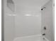 All-white tiled shower and bath combo at 6601 13Th N St, St Petersburg, FL 33702