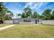 Inviting single-story home with a well-manicured lawn and white fence at 6601 13Th N St, St Petersburg, FL 33702