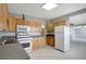 Kitchen with white refrigerator, wooden cabinets, microwave, and light gray countertops at 6601 13Th N St, St Petersburg, FL 33702