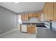 Kitchen with light wood cabinets, stainless steel sink, and white appliances at 6601 13Th N St, St Petersburg, FL 33702