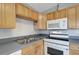 Kitchen featuring light wood cabinets, gray countertops, and stainless steel sink at 6601 13Th N St, St Petersburg, FL 33702