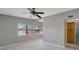 Bright living room with large windows, ceiling fan, and tile flooring at 6601 13Th N St, St Petersburg, FL 33702