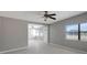 Light-filled living room with tile floors and view to the entrance with glass door at 6601 13Th N St, St Petersburg, FL 33702
