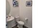 Cozy half bathroom featuring stylish art, pedestal sink, and modern toilet at 7563 Ashcroft Dr, Wesley Chapel, FL 33545