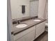Modern bathroom featuring double sinks, granite countertop, and stylish fixtures at 7563 Ashcroft Dr, Wesley Chapel, FL 33545