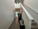 Inviting hallway with wood-look floors, a staircase, a fish tank and views into the living area at 7563 Ashcroft Dr, Wesley Chapel, FL 33545
