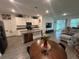 Open concept kitchen with island, stainless steel appliances, lots of cabinets, and adjacent living area at 7563 Ashcroft Dr, Wesley Chapel, FL 33545