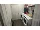 Convenient laundry room with washer, dryer, and shelving for storage at 7563 Ashcroft Dr, Wesley Chapel, FL 33545