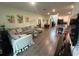 Spacious open-concept living area with a large couch, wood-look flooring and access to kitchen at 7563 Ashcroft Dr, Wesley Chapel, FL 33545