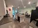 Open floor plan of kitchen and living area with lots of light and wood-look flooring throughout at 7563 Ashcroft Dr, Wesley Chapel, FL 33545