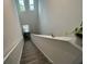 Well-lit staircase with neutral carpet and white railing at 7563 Ashcroft Dr, Wesley Chapel, FL 33545