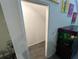Small storage area is shown off of a hallway with a fish tank and stairway at 7563 Ashcroft Dr, Wesley Chapel, FL 33545
