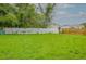 Large backyard featuring green grass, a privacy fence, and mature trees adding natural beauty at 7620 N 74Th St, Pinellas Park, FL 33781