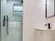 Contemporary bathroom featuring a glass-enclosed shower, a modern shower head, and a vanity at 7620 N 74Th St, Pinellas Park, FL 33781