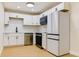 Modern kitchen with white cabinets, stainless steel appliances, and a sleek, contemporary design at 7620 N 74Th St, Pinellas Park, FL 33781