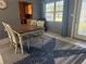 Bright dining area features a rustic wood table, white chairs, and a patterned rug for a welcoming ambiance at 7800 125Th St, Seminole, FL 33772