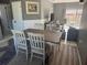 Inviting dining room with a wood table, white chairs, and sliding glass doors to the outdoor space at 7800 125Th St, Seminole, FL 33772