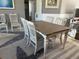 Charming dining area with a wooden table, white chairs, and a patterned rug for a cozy feel at 7800 125Th St, Seminole, FL 33772