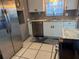 The kitchen offers stainless steel appliances, white cabinetry, and light countertops at 7800 125Th St, Seminole, FL 33772