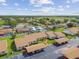 Community aerial view highlighting manicured lawns, lush trees, and convenient parking options at 7923 Radcliffe Cir, Port Richey, FL 34668