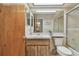 Bathroom featuring a large mirror and vanity with a shower with frosted glass doors at 7923 Radcliffe Cir, Port Richey, FL 34668