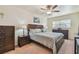 Cozy bedroom features neutral color scheme, ceiling fan, and furnishings at 7923 Radcliffe Cir, Port Richey, FL 34668