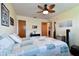 Bright bedroom with a decorative ceiling fan, a spacious closet, and unique accents at 7923 Radcliffe Cir, Port Richey, FL 34668