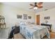 Bedroom featuring a desk, computer, ceiling fan, and wall decor at 7923 Radcliffe Cir, Port Richey, FL 34668