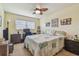 Bedroom with a desk, computer, ceiling fan, and wall decor at 7923 Radcliffe Cir, Port Richey, FL 34668