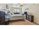 Neutral bedroom featuring a ceiling fan, dresser, and mounted TV at 7923 Radcliffe Cir, Port Richey, FL 34668