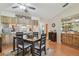 Charming dining room with wood floors, a ceiling fan, and an open view of the kitchen with stainless steel appliances at 7923 Radcliffe Cir, Port Richey, FL 34668