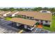 Aerial view of the property showcasing covered parking, guest spaces, and meticulously maintained landscaping at 7923 Radcliffe Cir, Port Richey, FL 34668