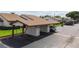 Exterior of the property featuring covered parking, well-maintained landscaping, and guest parking at 7923 Radcliffe Cir, Port Richey, FL 34668