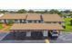 Aerial view of the property showing covered parking, guest parking, and manicured landscaping at 7923 Radcliffe Cir, Port Richey, FL 34668