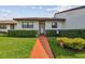 Charming single-story home with manicured lawn, tidy hedges, and a welcoming walkway to the front door at 7923 Radcliffe Cir, Port Richey, FL 34668