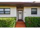 Charming single-story home with manicured lawn, tidy hedges, and a welcoming walkway to the front door at 7923 Radcliffe Cir, Port Richey, FL 34668