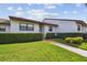 Charming single-story home with manicured lawn, tidy hedges, and a welcoming walkway to the front door at 7923 Radcliffe Cir, Port Richey, FL 34668