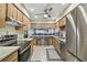 Open kitchen layout with stainless steel appliances and a breakfast bar overlooking the living area at 7923 Radcliffe Cir, Port Richey, FL 34668