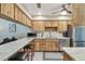 Bright kitchen featuring light wood cabinets, stainless steel appliances, and a breakfast bar for casual dining at 7923 Radcliffe Cir, Port Richey, FL 34668
