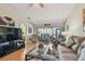 Inviting living room filled with natural light featuring comfortable seating, modern decor, and access to outdoor space at 7923 Radcliffe Cir, Port Richey, FL 34668
