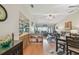 Open-concept living space with wood floors, modern furniture, and sliding glass doors to the outside at 7923 Radcliffe Cir, Port Richey, FL 34668