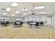 Resident meeting room with tables, chairs, and abundant natural light at 7923 Radcliffe Cir, Port Richey, FL 34668