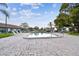 Beautiful community pool with a paved patio and lounge chairs for residents at 7923 Radcliffe Cir, Port Richey, FL 34668