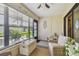 Bright sun room with large windows, wicker seating, and outdoor views, offering a tranquil space at 7923 Radcliffe Cir, Port Richey, FL 34668